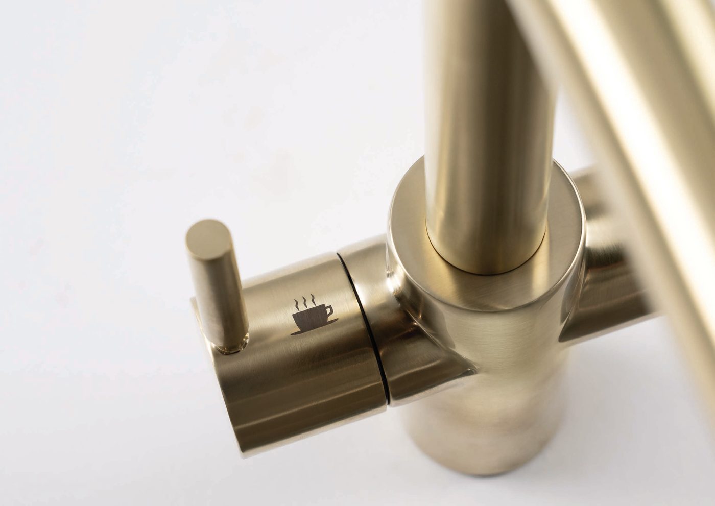 Detalle de la palanca de agua caliente de un grifo InSinkErator dorado